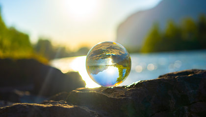 A Glass ball surrounded by nature. In the back you can see the river called Inn. | © Unsplash / Alin Andersen